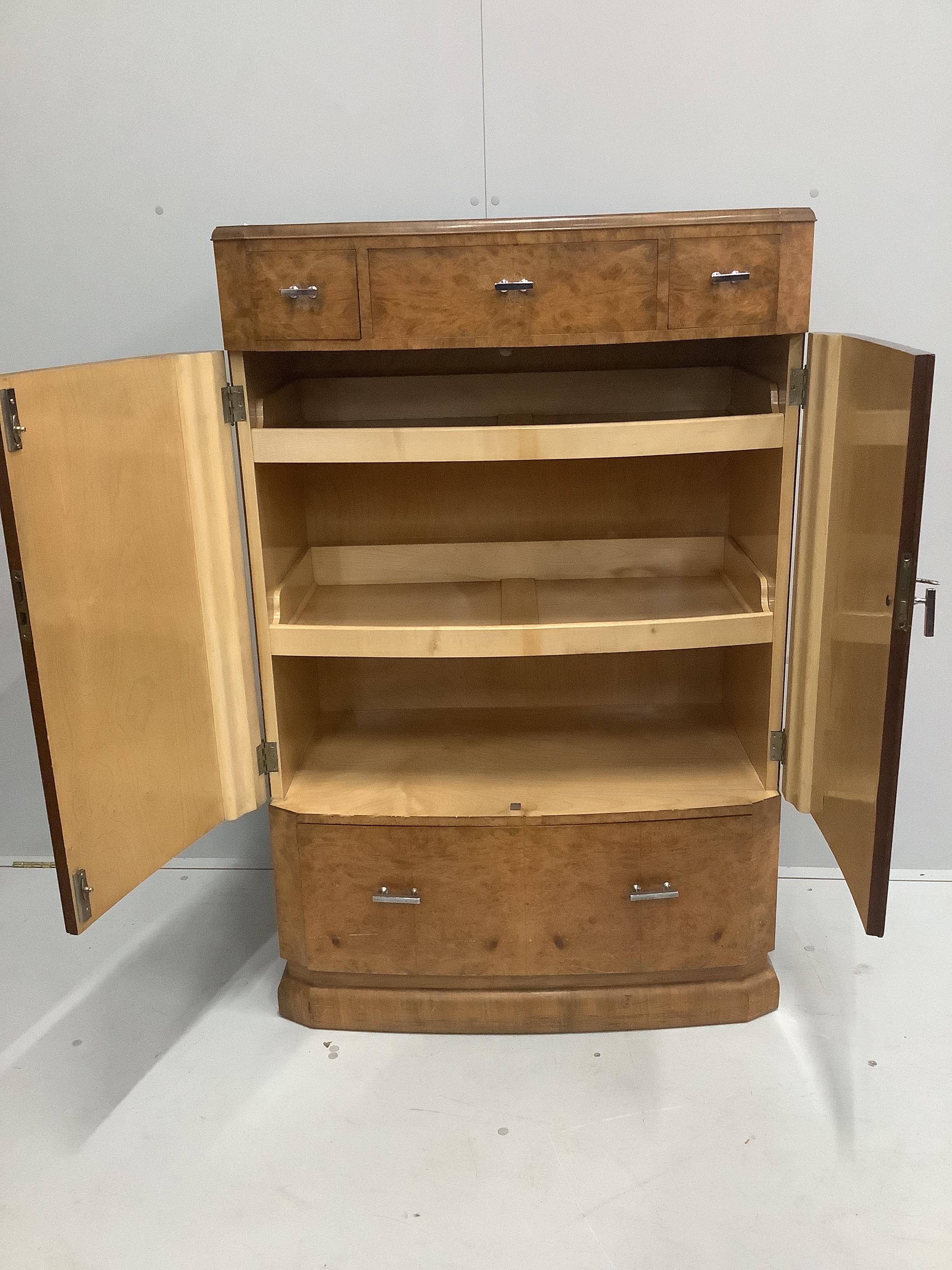 An Art Deco style burr walnut press cupboard, width 85cm, depth 48cm, height 129cm